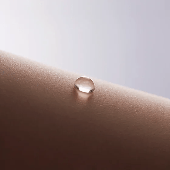 Close-up of NightCool fabric pulling a drop of sweat off skin and drying