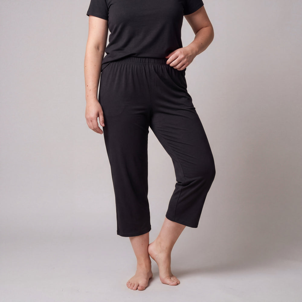 Black Cool-jams Women's NightCool Capri Pants, front view on a greige backdrop, mid-calf length with an elastic waist, breathable sleepwear for warm nights