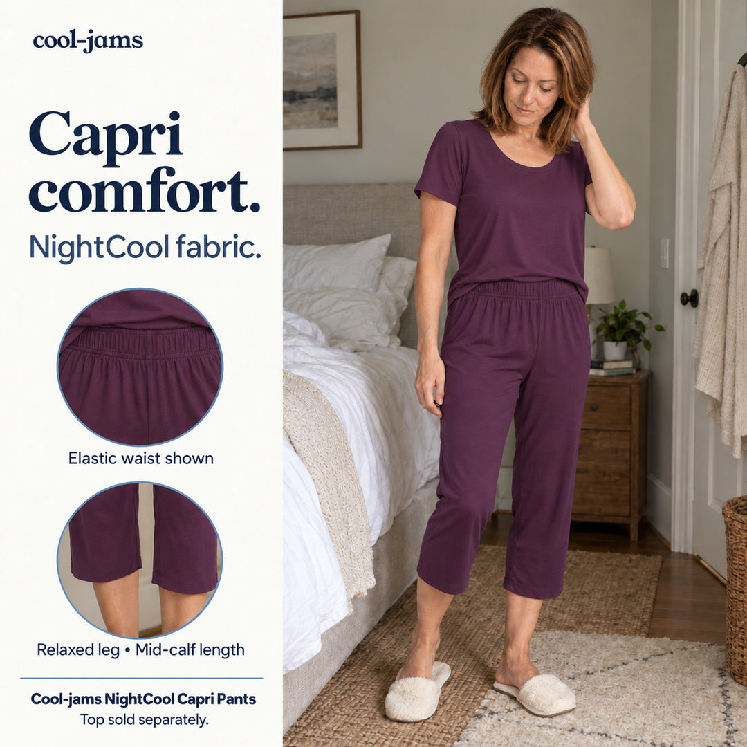 Woman standing beside a bed in a merlot Women's NightCool Scoop T-Shirt and Capri Pants, with close-ups of the elastic waist and mid-calf length, cooling pajamas for menopause