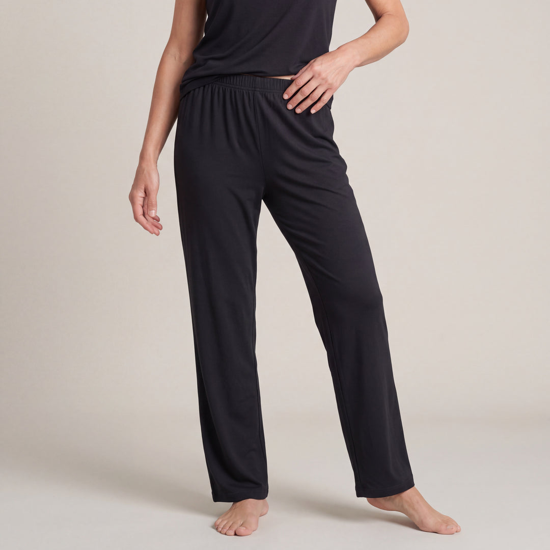 Black Cool-jams NightCool Pajama Pants for women, worn with a matching top, model standing with a hand on her hip