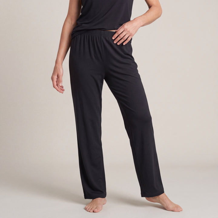Black Cool-jams NightCool Pajama Pants for women, worn with a matching top, model standing with a hand on her hip