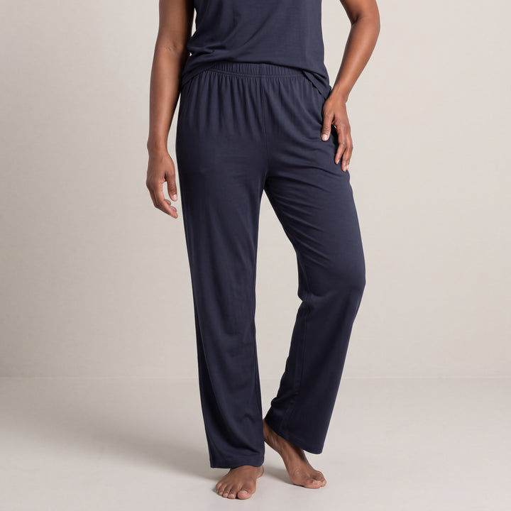 Navy Cool-jams NightCool Pajama Pants for women, worn with a matching top, model standing with a hand on her hip