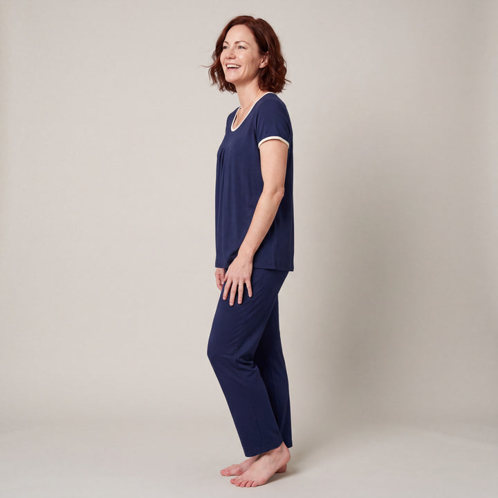 Navy Cool-jams NightCool Pleated T-Shirt for women with cream binding, worn with matching drawstring pants, side view, full length