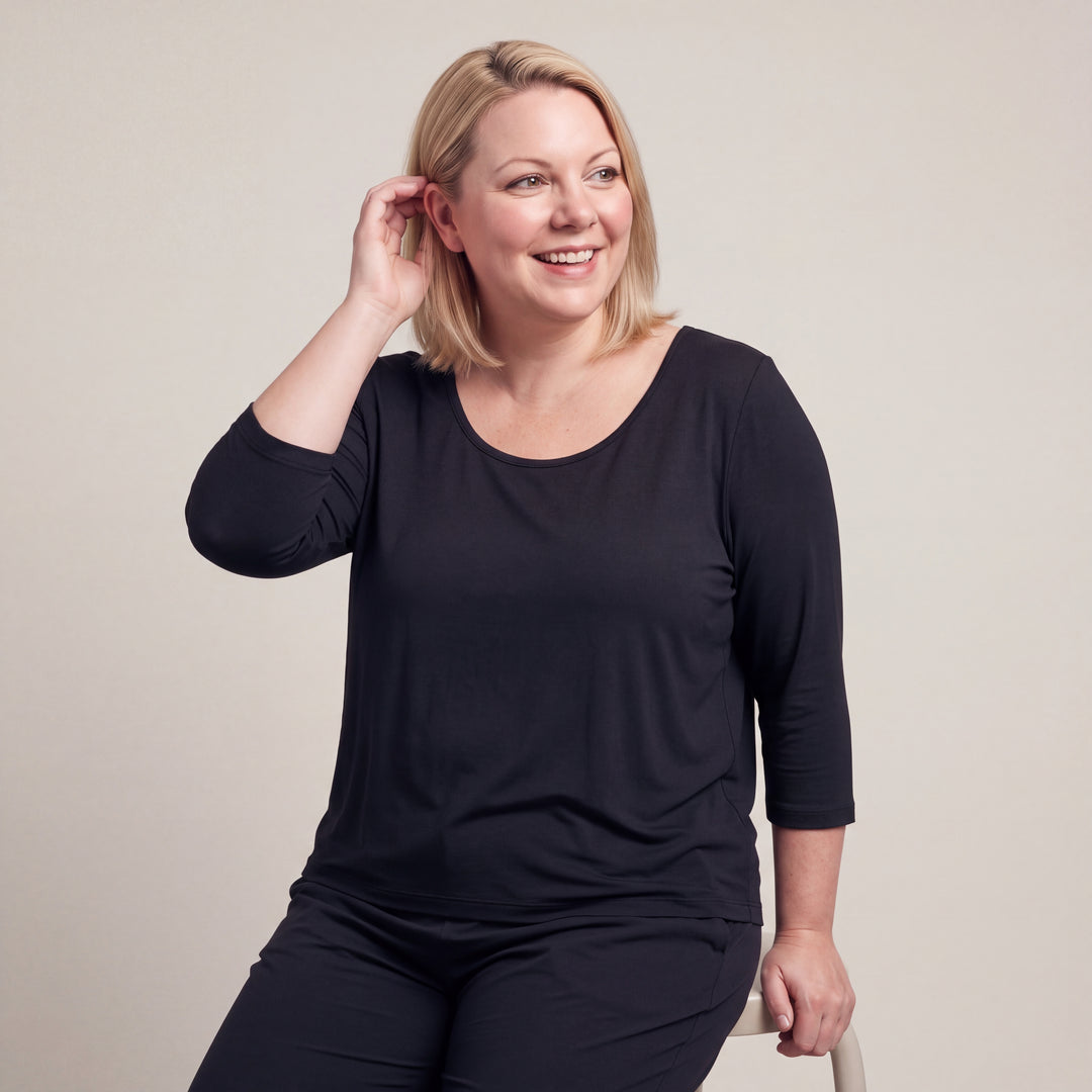 Black Cool-jams NightCool Scoop Neck T-Shirt - 3/4 Sleeves for women, worn with matching pants, model seated with a hand in her hair