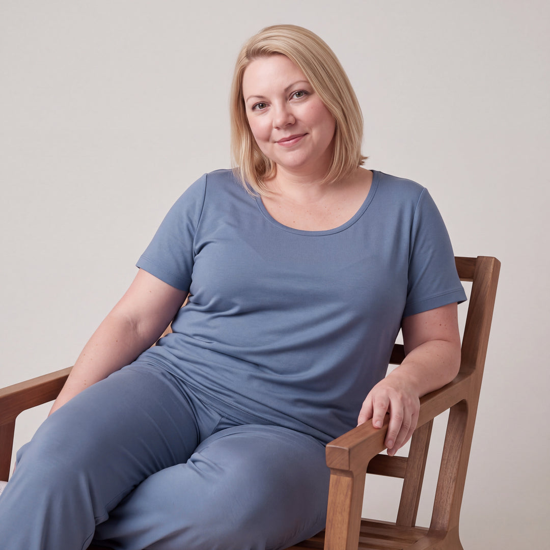 Dusk Blue Cool-jams NightCool Scoop T-Shirt for women, worn with matching pants, model seated in a wooden chair